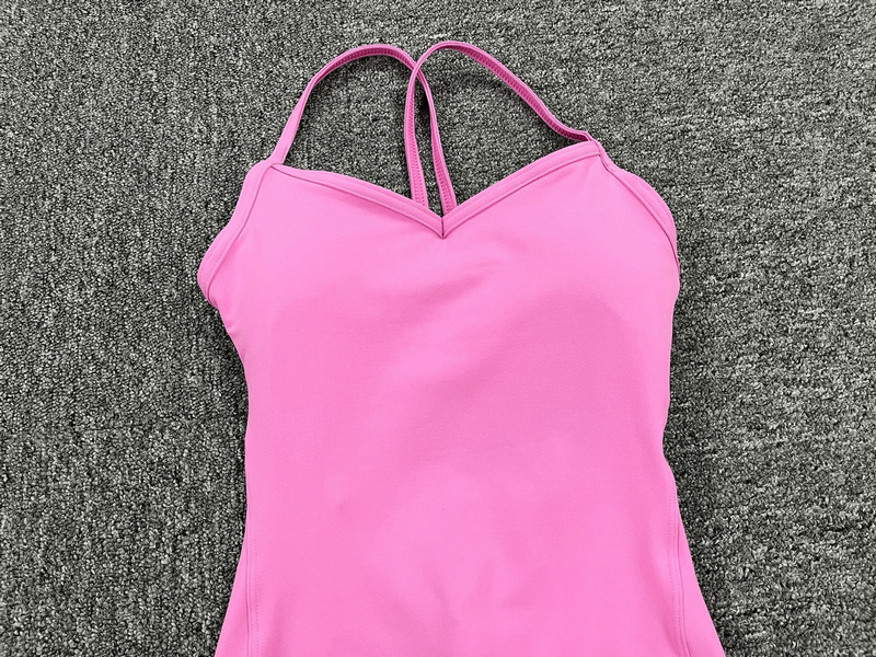 Pink V-neck seamless yoga jumpsuit with open back design for women, perfect for comfortable and stylish workouts. SF0066.